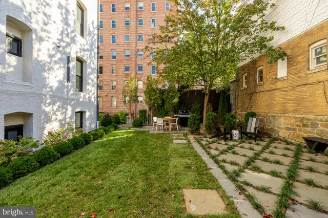 a view of a patio with table and chairs and potted plants