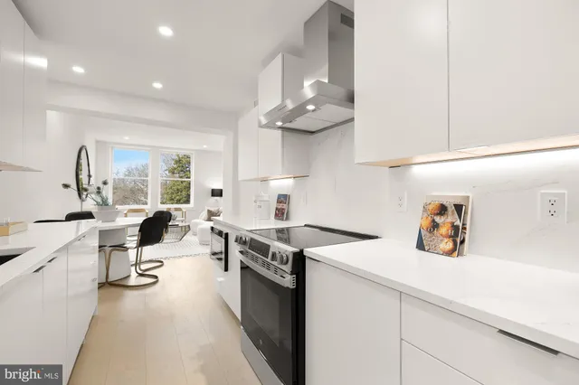 a kitchen with a stove a sink and a refrigerator