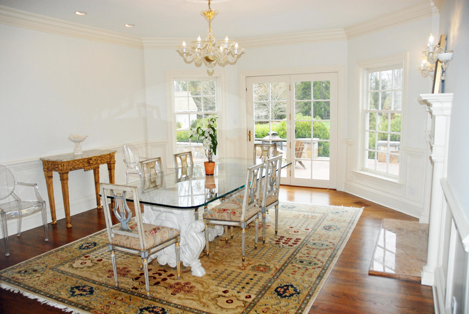 262 Lukes Wood Road New Canaan, CT 06840 - Photo 11 of 34 a view of a dining room with furniture a chandelier and wooden floor