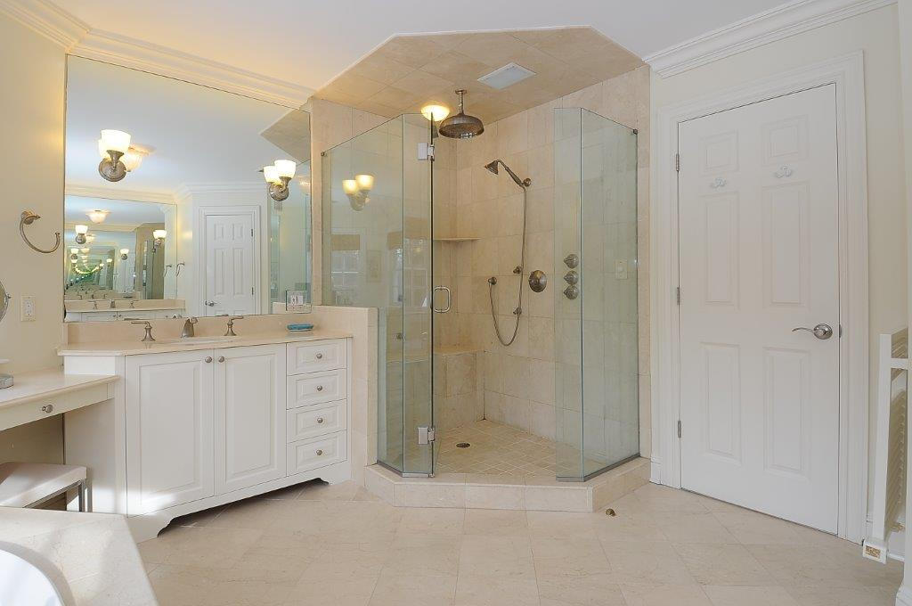 262 Lukes Wood Road New Canaan, CT 06840 - Photo 16 of 34 a bathroom with a double vanity sink mirror and shower