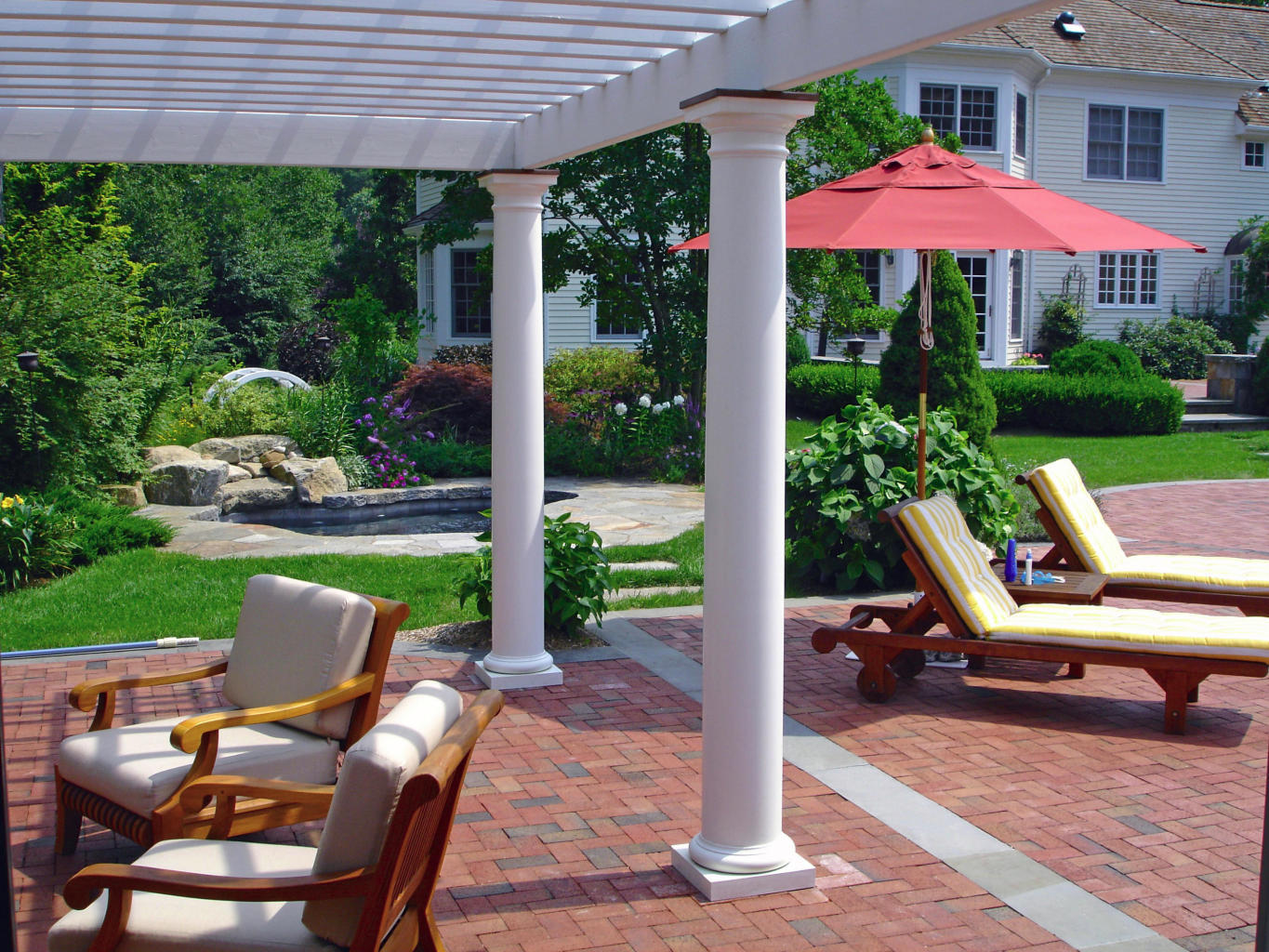 262 Lukes Wood Road New Canaan, CT 06840 - Photo 25 of 34 a view of a patio with table and chairs under an umbrella