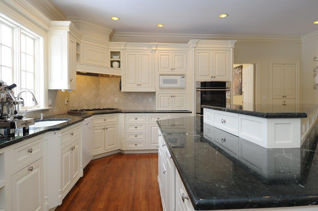 262 Lukes Wood Road New Canaan, CT 06840 - Photo 5 of 34 a kitchen with granite countertop white cabinets and stainless steel appliances