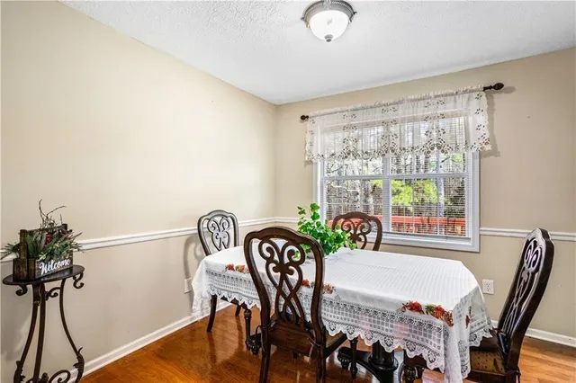 a living room with furniture two window and wooden floor