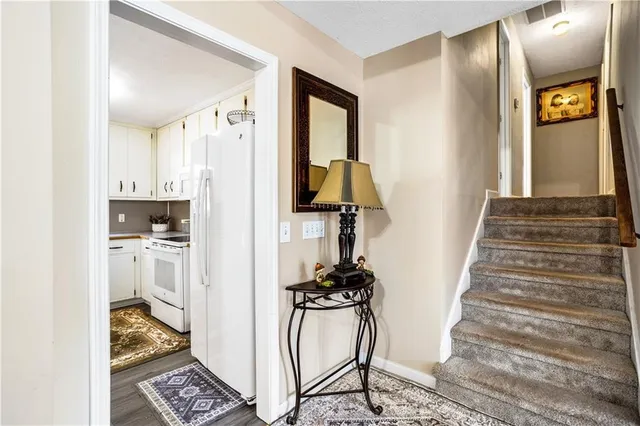 a kitchen with white cabinets and white appliances