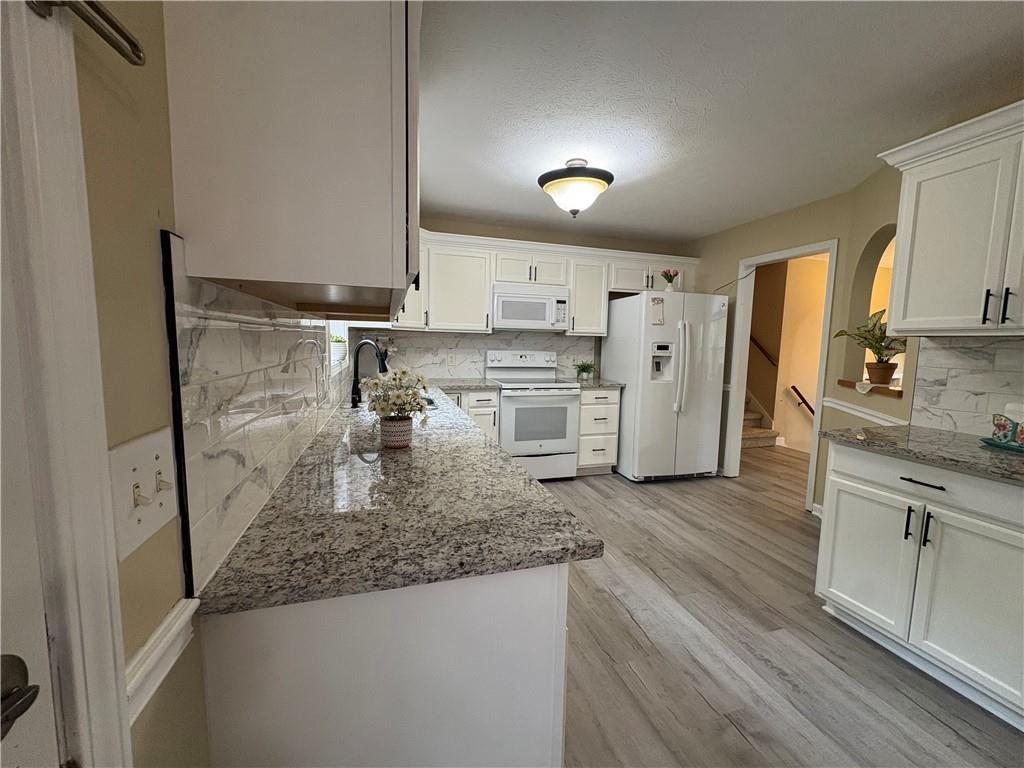 13 Greystone Lane Northwest Cartersville, GA 30121 - Photo 19 of 61 a kitchen with a sink stove and refrigerator