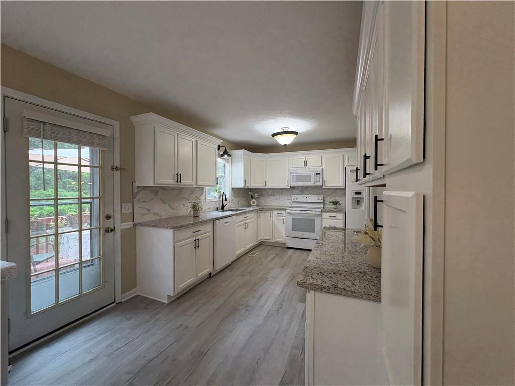 13 Greystone Lane Northwest Cartersville, GA 30121 - Photo 21 of 61 a kitchen with a refrigerator sink and cabinets