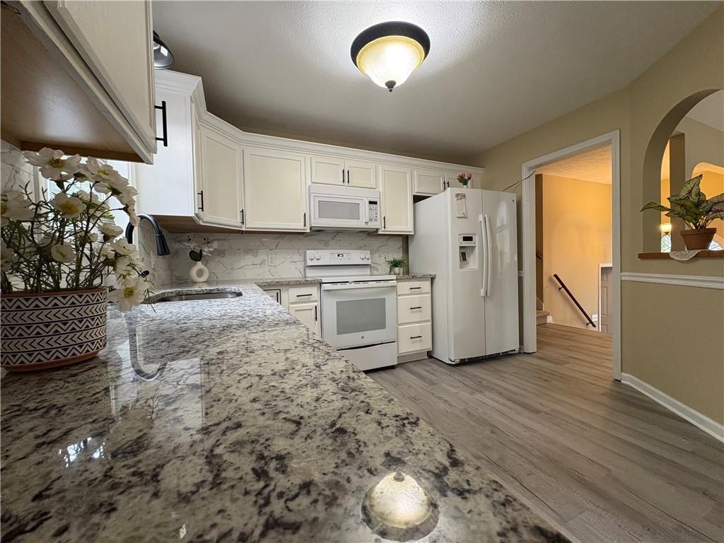 13 Greystone Lane Northwest Cartersville, GA 30121 - Photo 26 of 61 a kitchen with stainless steel appliances granite countertop a sink a stove a refrigerator and cabinets