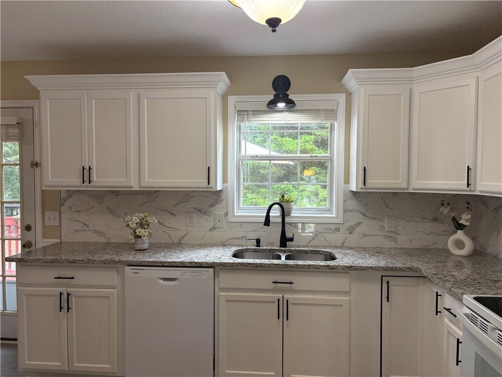 13 Greystone Lane Northwest Cartersville, GA 30121 - Photo 29 of 61 a kitchen with stainless steel appliances granite countertop white cabinets and a sink