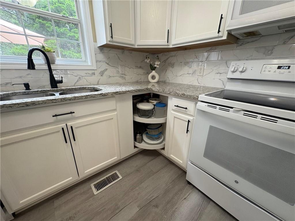 13 Greystone Lane Northwest Cartersville, GA 30121 - Photo 37 of 61 a kitchen with granite countertop white cabinets and a sink