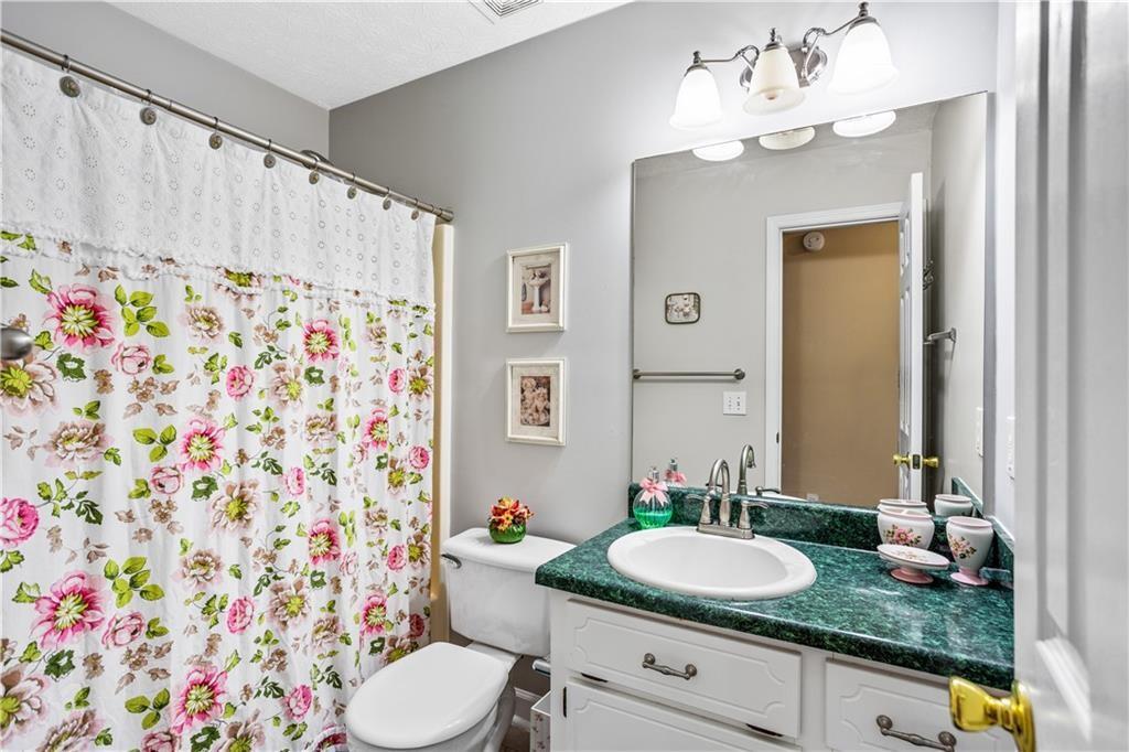 13 Greystone Lane Northwest Cartersville, GA 30121 - Photo 40 of 61 a bathroom with a granite countertop bathtub sink vanity mirror and toilet