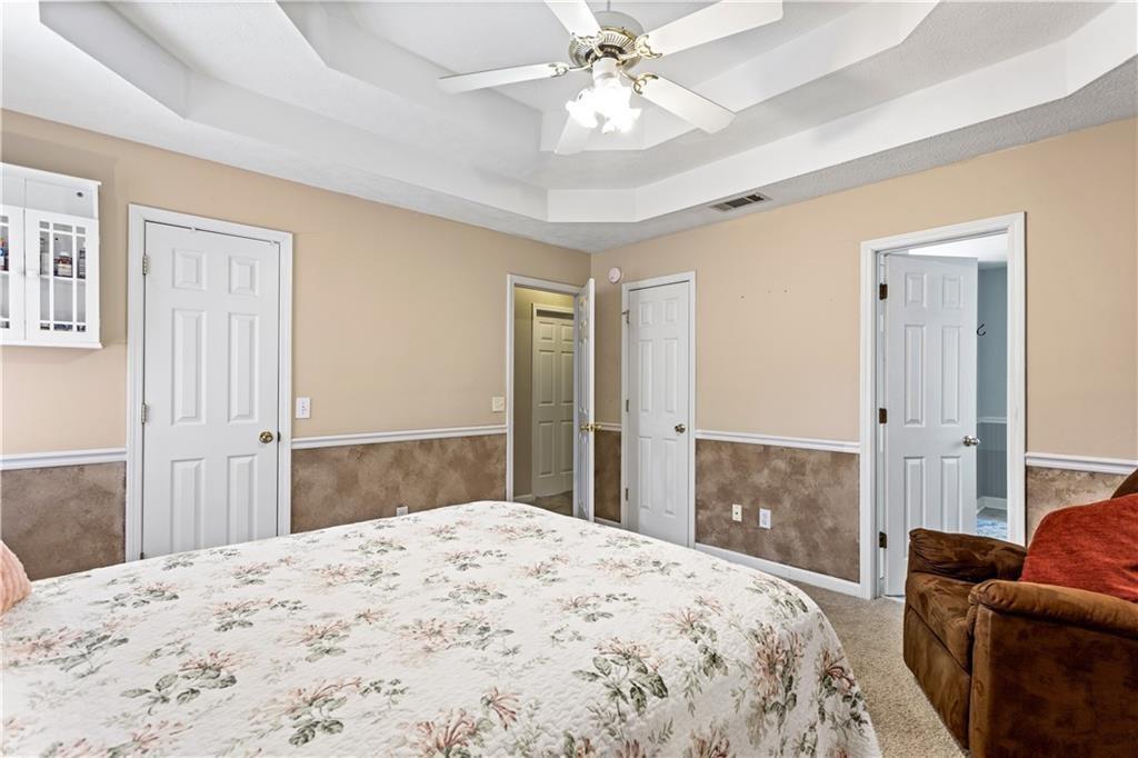 13 Greystone Lane Northwest Cartersville, GA 30121 - Photo 44 of 61 a bedroom with a bed dresser and a wooden floor