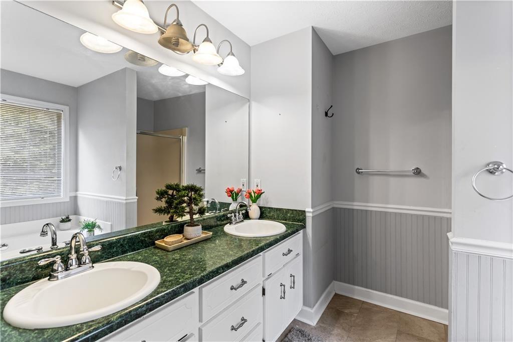 13 Greystone Lane Northwest Cartersville, GA 30121 - Photo 46 of 61 a bathroom with a double vanity sink and a mirror