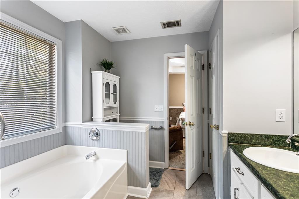 13 Greystone Lane Northwest Cartersville, GA 30121 - Photo 48 of 61 a bathroom with a granite countertop tub sink and mirror