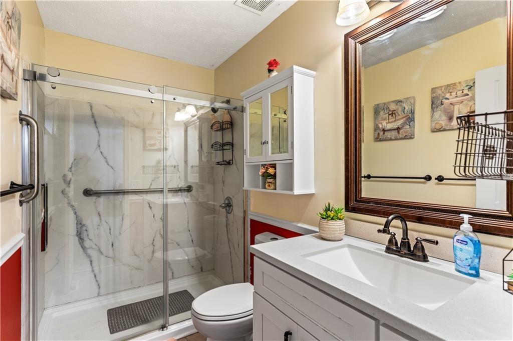 13 Greystone Lane Northwest Cartersville, GA 30121 - Photo 52 of 61 a bathroom with a sink toilet and shower