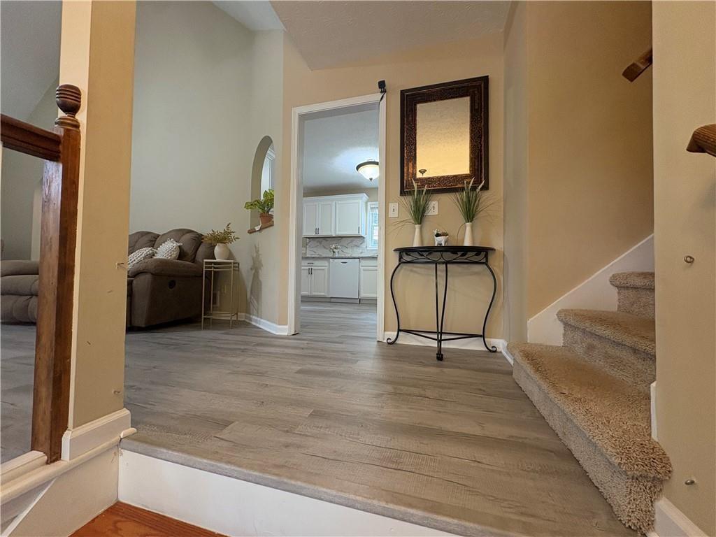 13 Greystone Lane Northwest Cartersville, GA 30121 - Photo 8 of 61 a hallway with a couch and chandelier