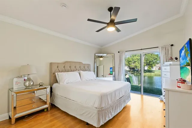 a bedroom with a bed and large window