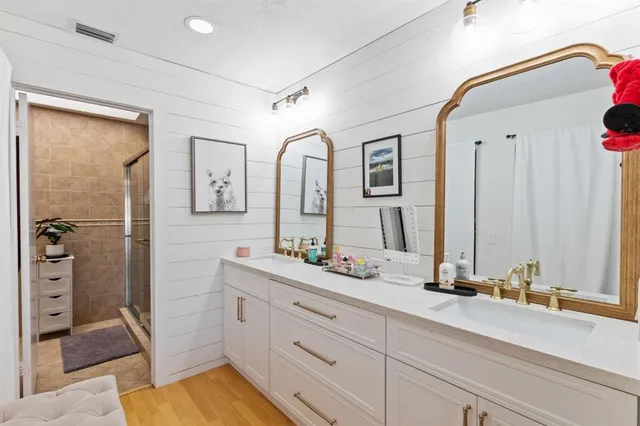 a bathroom with a double vanity sink mirror and double