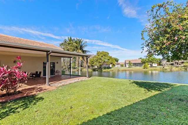 a view of a house with a yard and a fountain