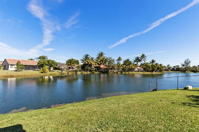 a view of a lake with boats and trees in the background