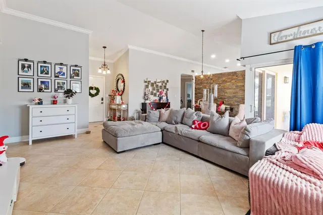a living room with furniture and a chandelier