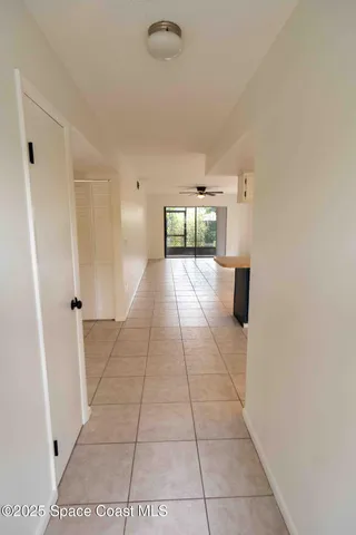 a view of a livingroom with an empty space and a window