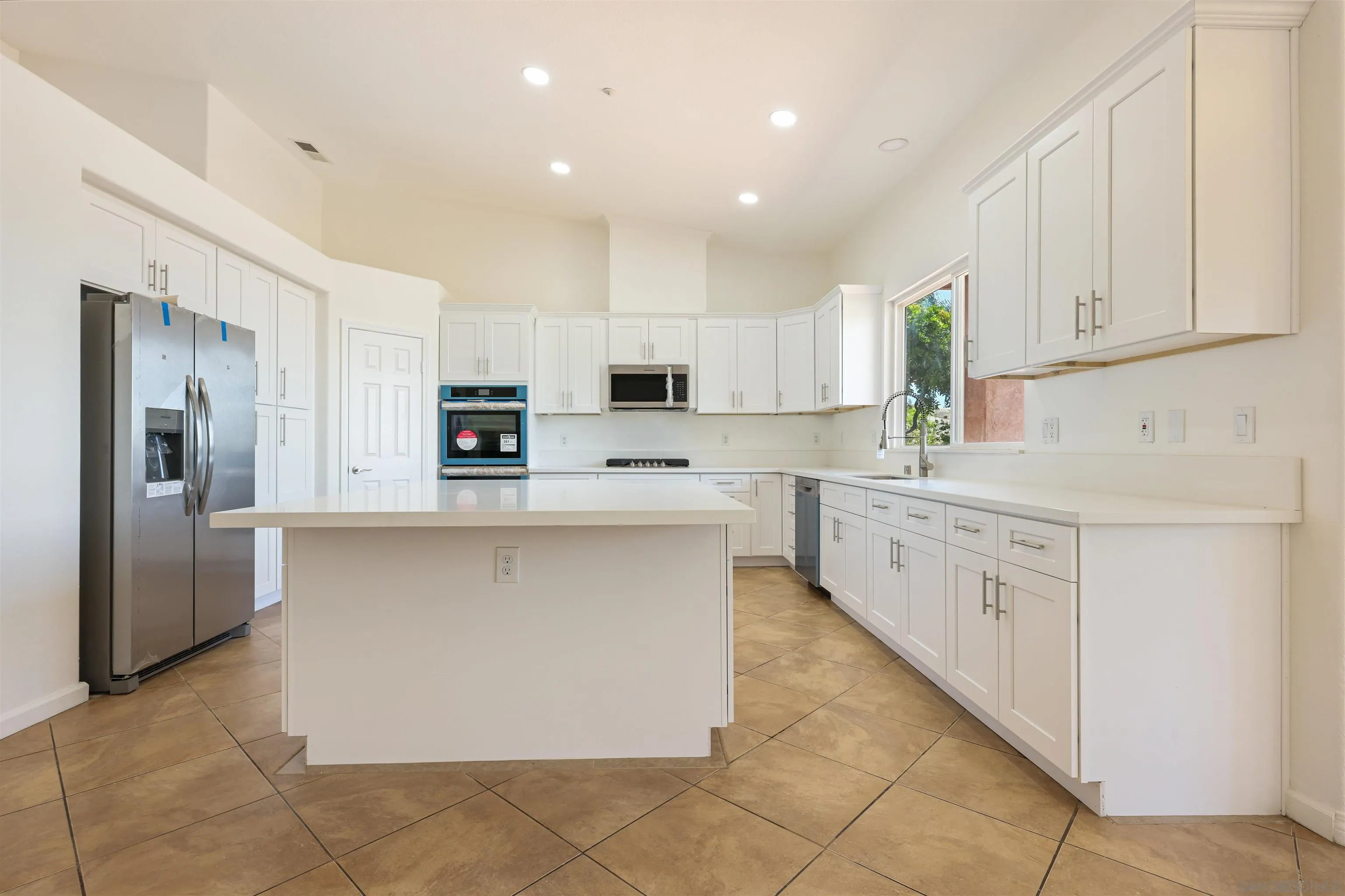 26335 Engelmann Road Valley Center, CA 92082 - Photo 13 of 42 a kitchen with stainless steel appliances a refrigerator sink and cabinets