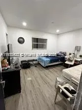 a living room with lots of furniture and kitchen view