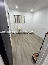 an empty room with wooden floor