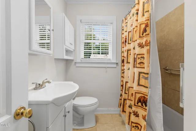 a view of a room with wooden floor and a kitchen