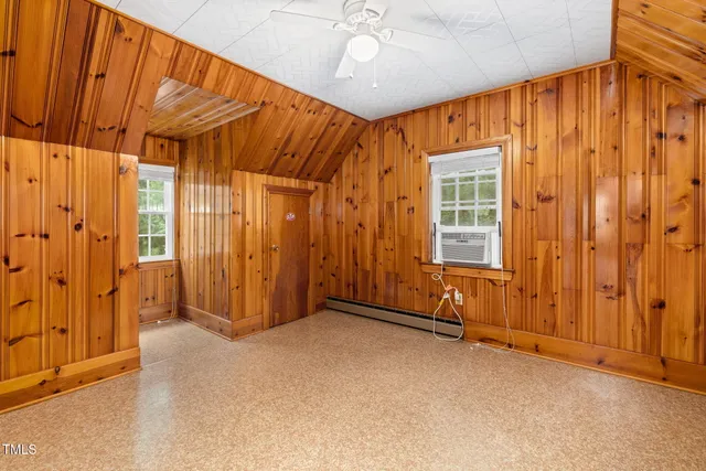 a view of a room with wooden floor and ceiling fan
