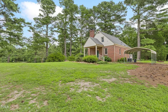 a picture of a very nice looking living room with a white wall and a painting