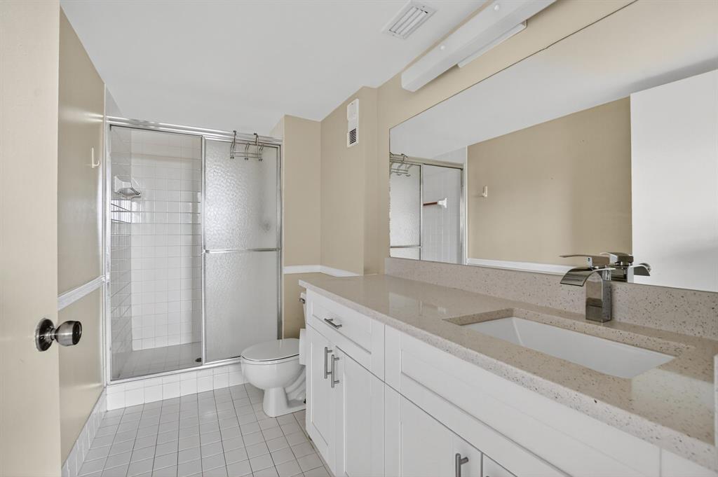 2236 North Cypress Bend Drive, Unit 508 Pompano Beach, FL 33069 - Photo 17 of 69 a bathroom with a sink a toilet and shower