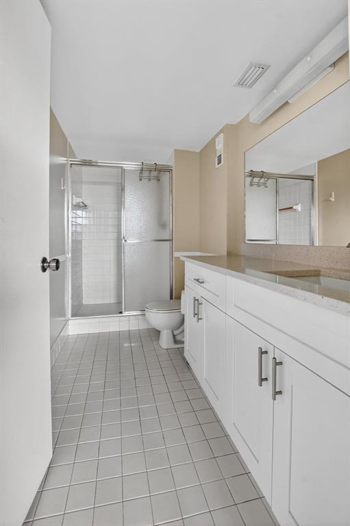 2236 North Cypress Bend Drive, Unit 508 Pompano Beach, FL 33069 - Photo 18 of 69 a bathroom with a sink a toilet and large mirror