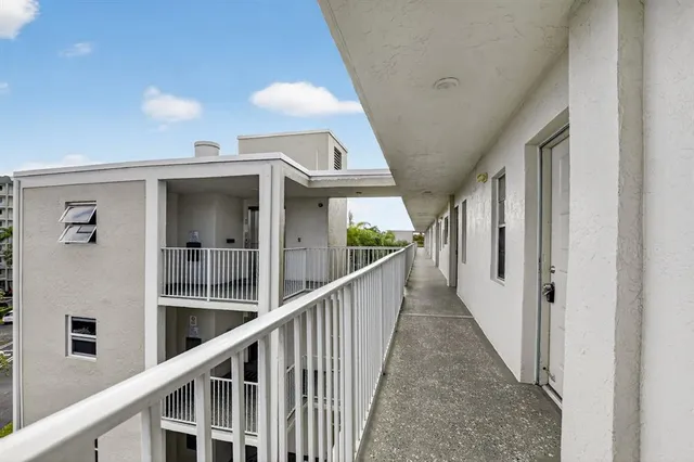 a view of a swimming pool with a patio and a garden
