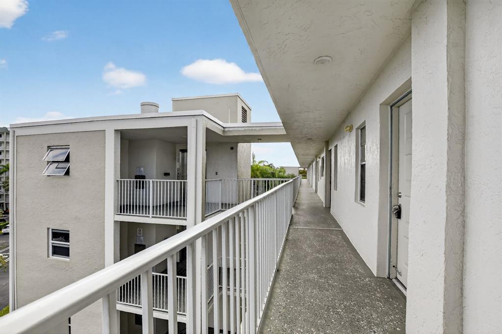 2236 North Cypress Bend Drive, Unit 508 Pompano Beach, FL 33069 - Photo 25 of 69 a view of a hallway view with staircase