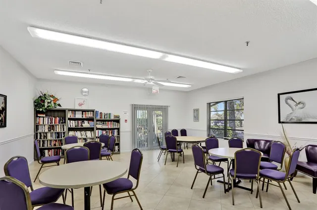 a living room with furniture a rug and white walls