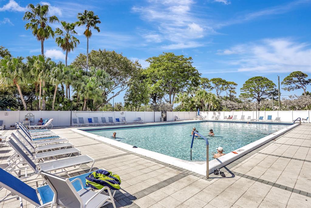 2236 North Cypress Bend Drive, Unit 508 Pompano Beach, FL 33069 - Photo 45 of 69 a view of a swimming pool with an outdoor seating