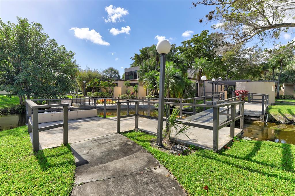 2236 North Cypress Bend Drive, Unit 508 Pompano Beach, FL 33069 - Photo 48 of 69 a view of a garden with patio