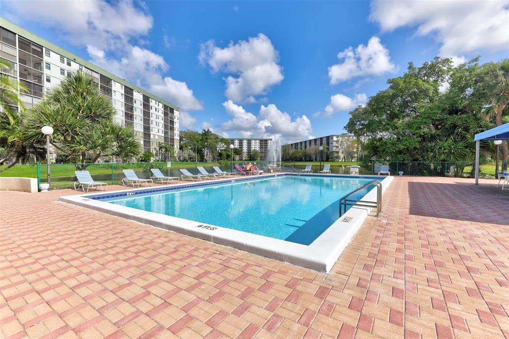 2236 North Cypress Bend Drive, Unit 508 Pompano Beach, FL 33069 - Photo 50 of 69 a view of a swimming pool with a patio