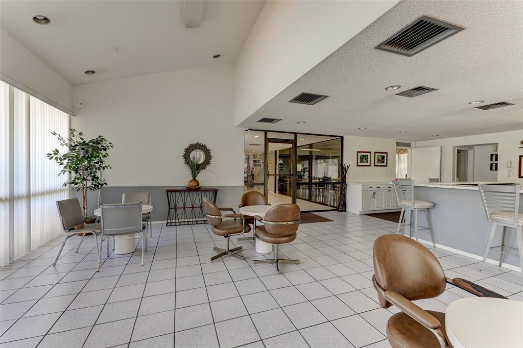 2236 North Cypress Bend Drive, Unit 508 Pompano Beach, FL 33069 - Photo 58 of 69 a living room with furniture and wooden floor