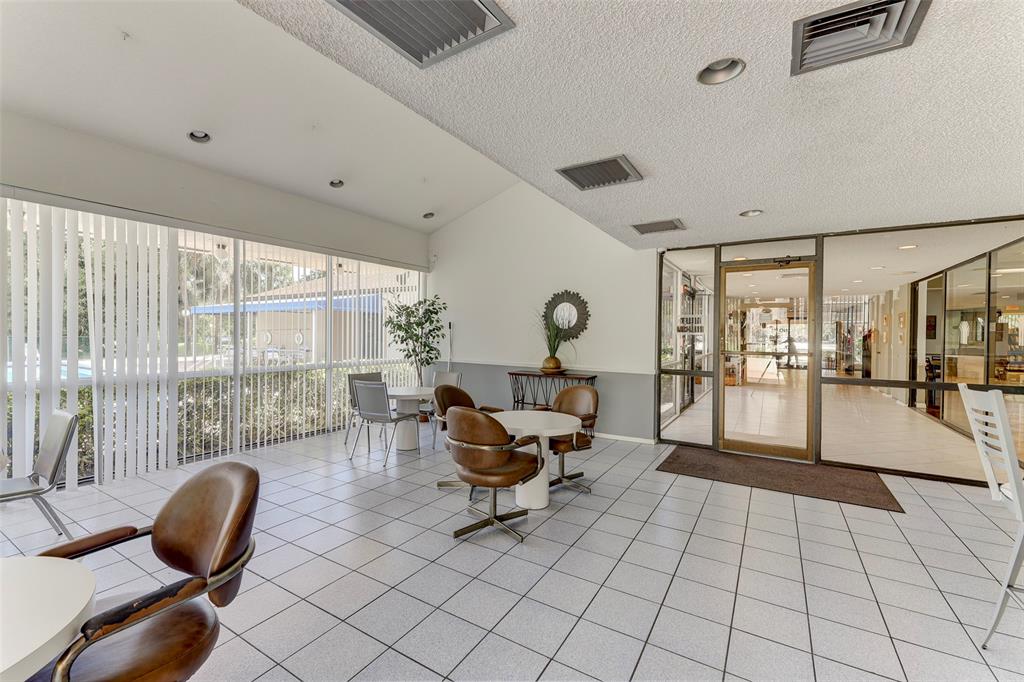2236 North Cypress Bend Drive, Unit 508 Pompano Beach, FL 33069 - Photo 60 of 69 a living room with furniture and a large window