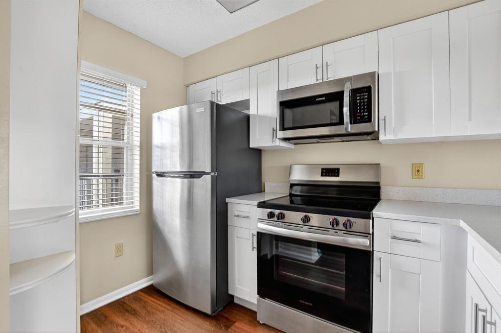 2236 North Cypress Bend Drive, Unit 508 Pompano Beach, FL 33069 - Photo 6 of 69 a kitchen with stainless steel appliances a stove microwave and refrigerator
