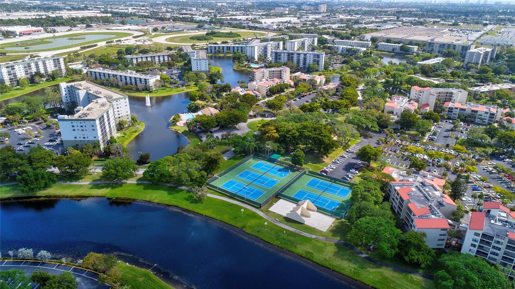 2236 North Cypress Bend Drive, Unit 508 Pompano Beach, FL 33069 - Photo 63 of 69 a view of a lake with a building in the background
