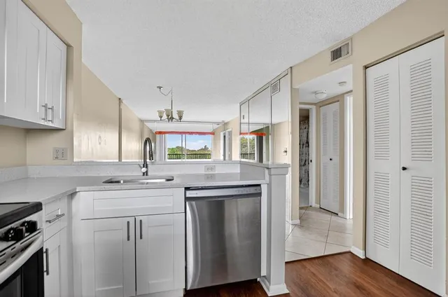 a view of a room with window a ceiling fan and refrigerator