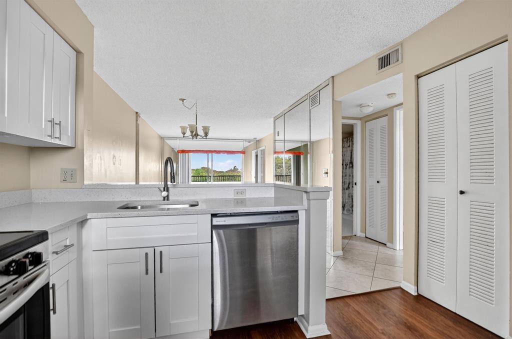 2236 North Cypress Bend Drive, Unit 508 Pompano Beach, FL 33069 - Photo 7 of 69 a kitchen with stainless steel appliances granite countertop a sink stove and refrigerator