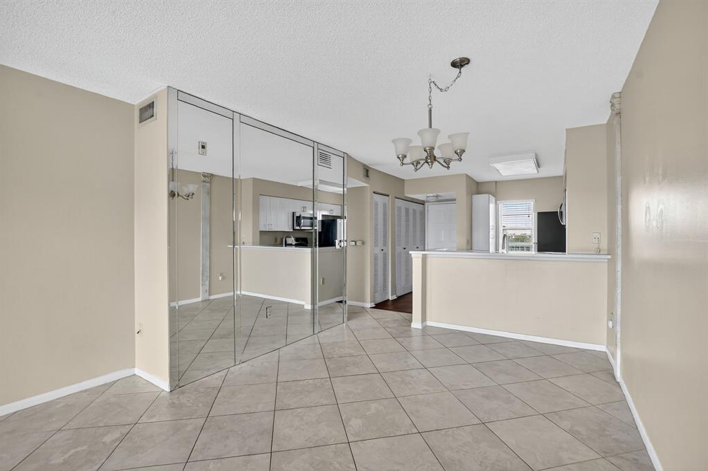 2236 North Cypress Bend Drive, Unit 508 Pompano Beach, FL 33069 - Photo 9 of 69 a view of a kitchen with a sink and refrigerator in it
