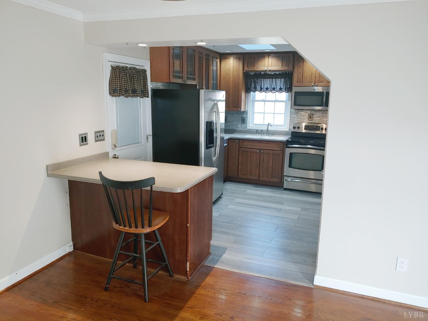 3941 Shula Drive Hurt, VA 24563 - Photo 35 of 67 a kitchen with stainless steel appliances a dining table chairs and granite counter tops