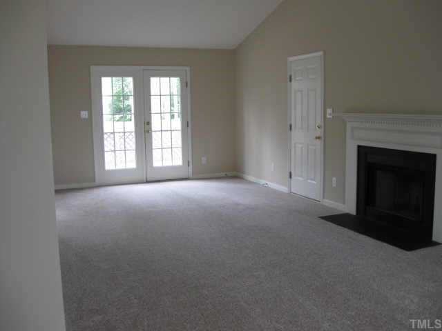 8104 Finland Drive Raleigh, NC 27612 - Photo 2 of 10 Large living room w/vaulted ceiling, fireplace and ceiling fan. French doors lead to deck. Other
