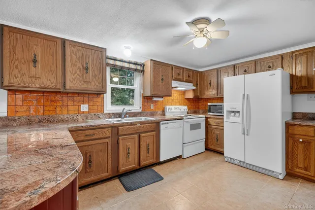 a kitchen with refrigerator cabinets and stove