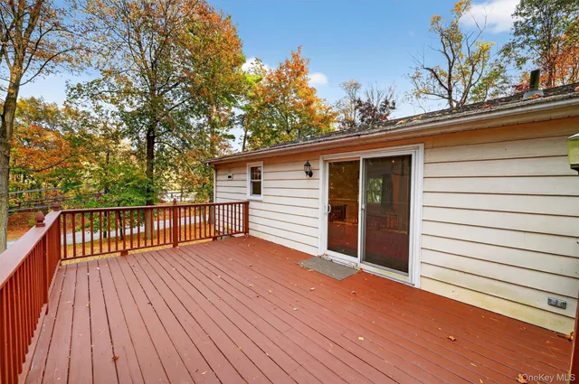 a view of backyard with a deck and wooden floor